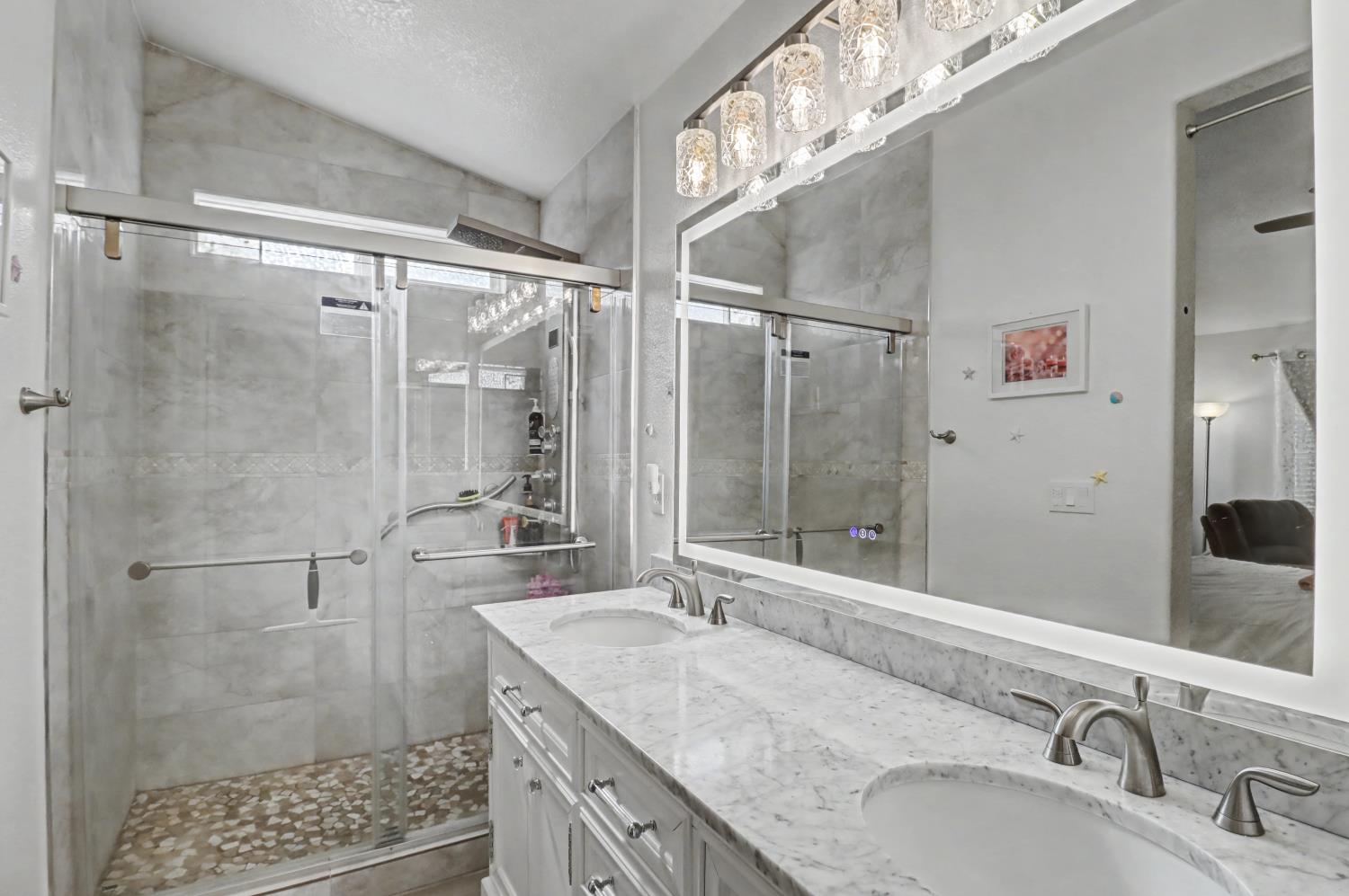 10056 Wexted Way Elk Grove, CA 95757 - Photo 33 of 39 a bathroom with a granite countertop shower sink vanity and a mirror