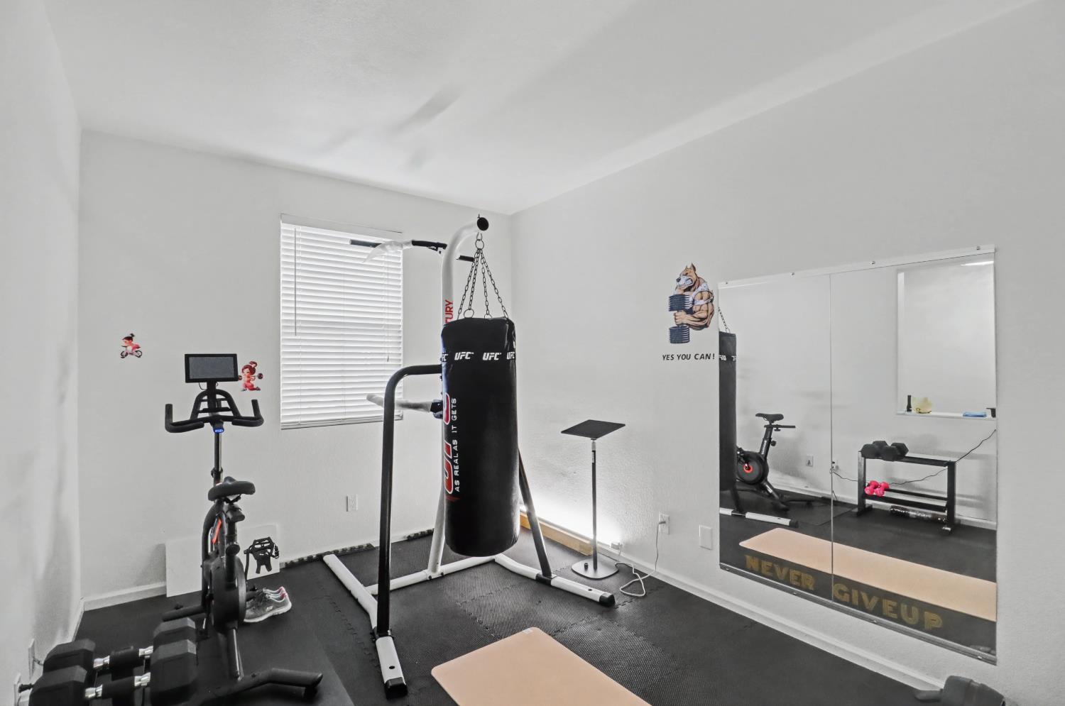 10056 Wexted Way Elk Grove, CA 95757 - Photo 6 of 39 a room with gym equipment and windows