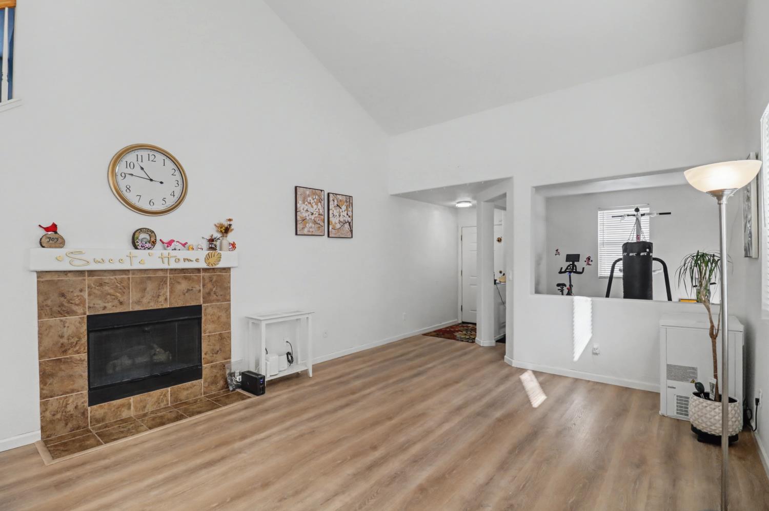 10056 Wexted Way Elk Grove, CA 95757 - Photo 9 of 39 a view of a room with wooden floor and a fireplace