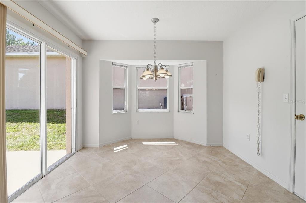 826 West Cockatiel Loop Hernando, FL 34442 - Photo 16 of 40 a view of an empty room with window and chandelier
