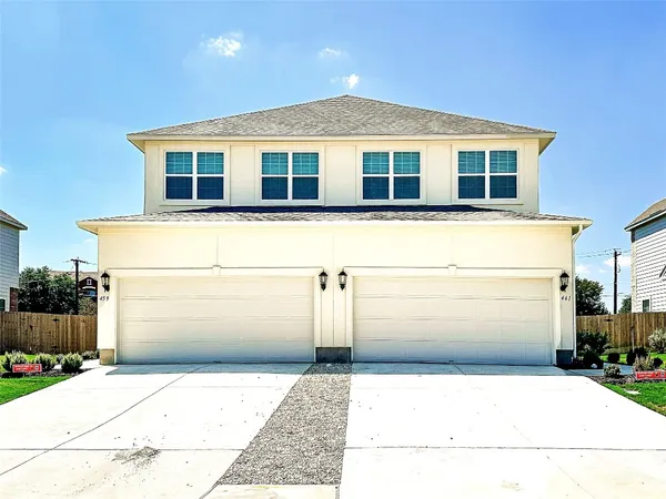 a front view of a house with a garage