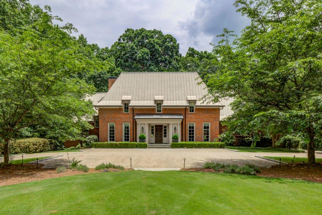 2350 Mt Paran Road Northwest Atlanta, GA 30327 - Photo 1 of 1 a front view of a house with a garden