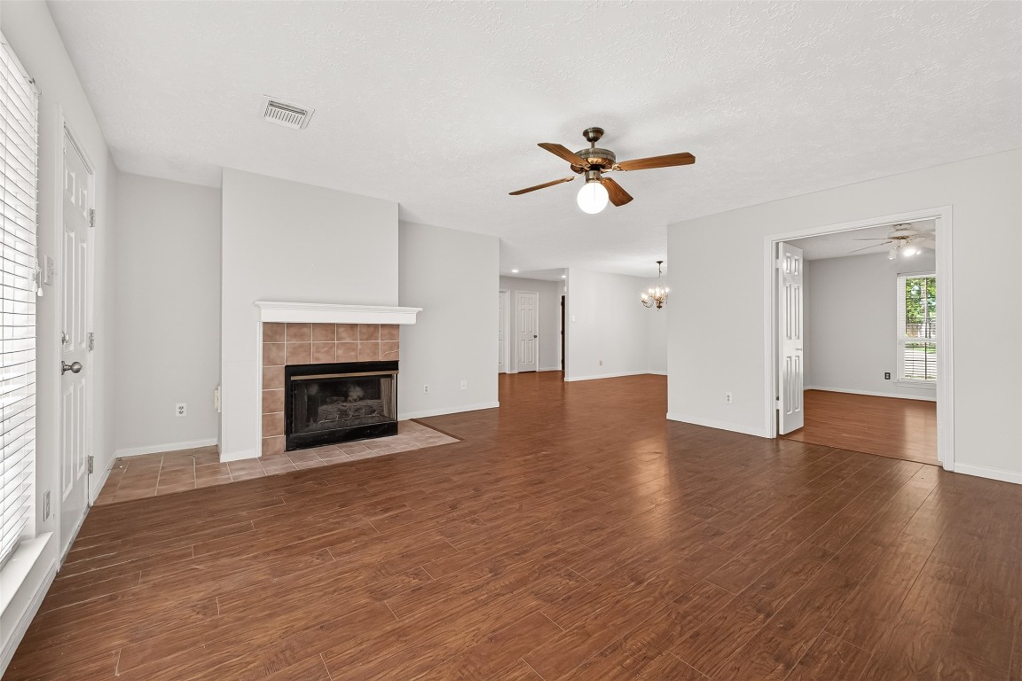 3506 Doherty Place Katy, TX 77449 - Photo 12 of 50 a view of empty room with a fireplace and wooden floor