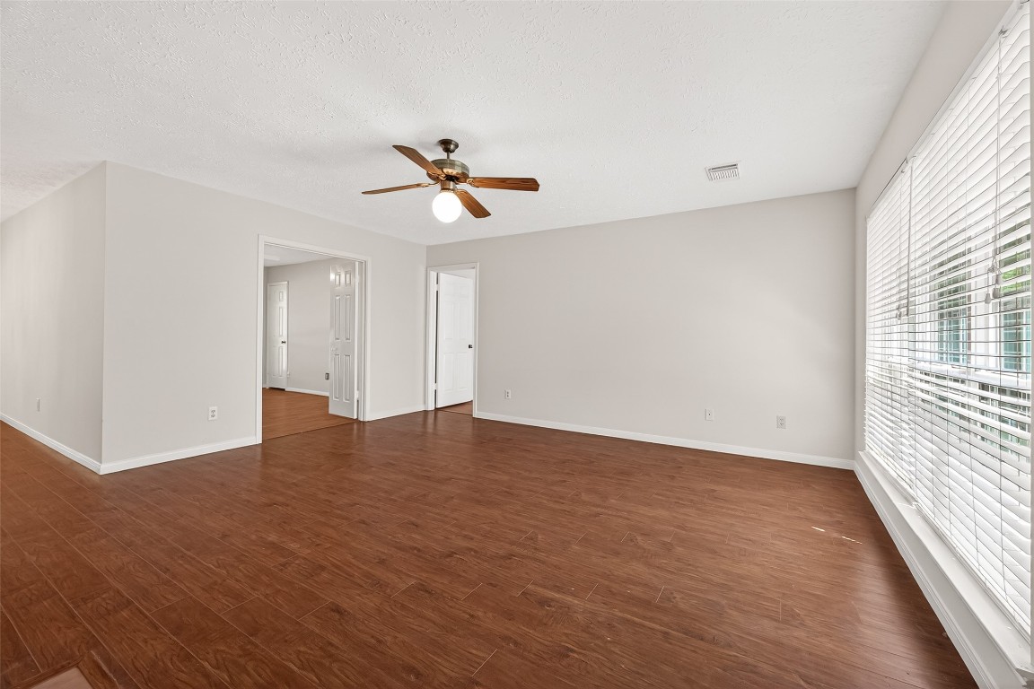 3506 Doherty Place Katy, TX 77449 - Photo 13 of 50 a view of empty room with wooden floor and fan