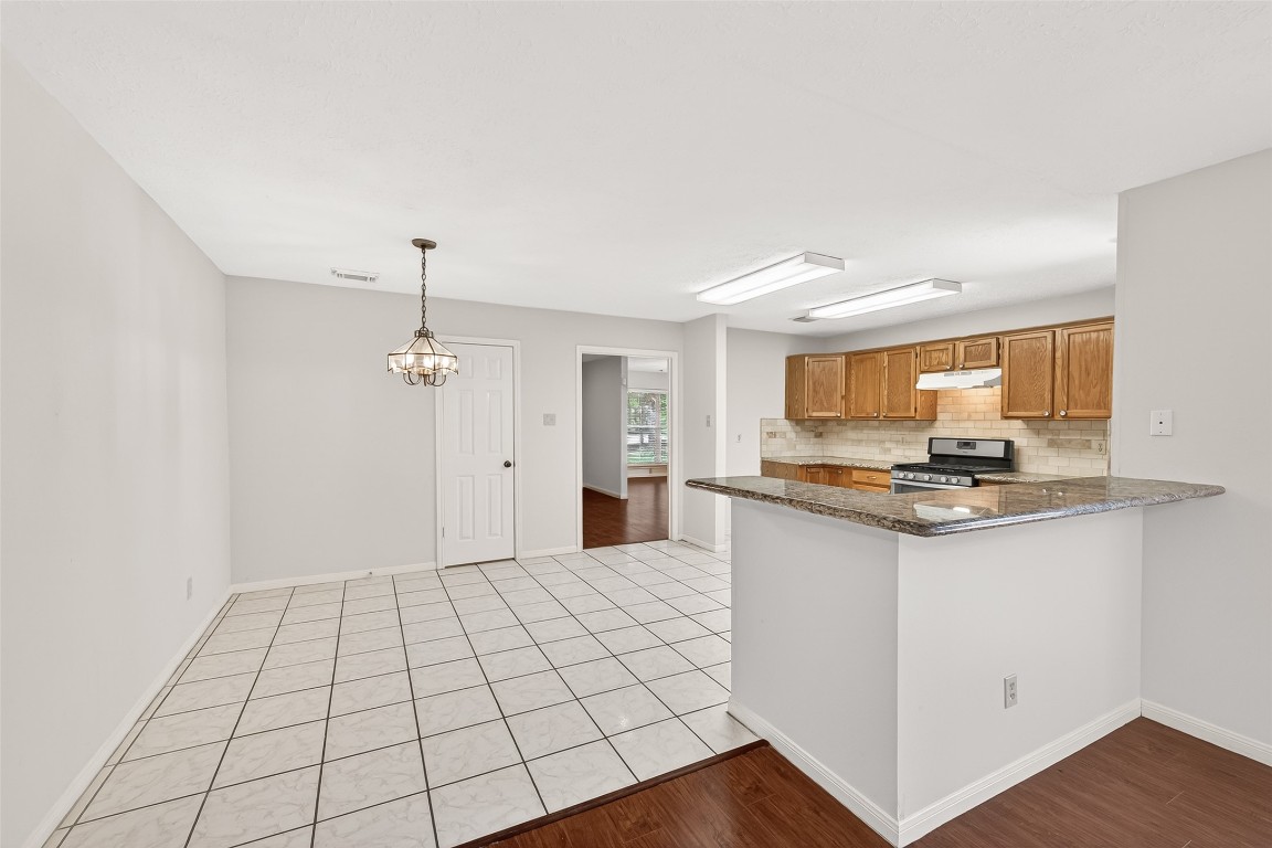3506 Doherty Place Katy, TX 77449 - Photo 15 of 50 a kitchen with granite countertop a sink cabinets and wooden floor