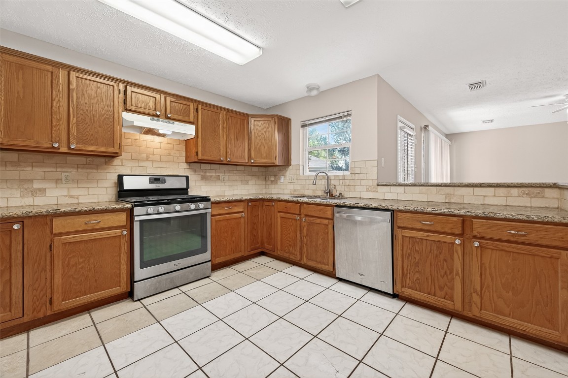 3506 Doherty Place Katy, TX 77449 - Photo 21 of 50 a kitchen with a sink stove and cabinets