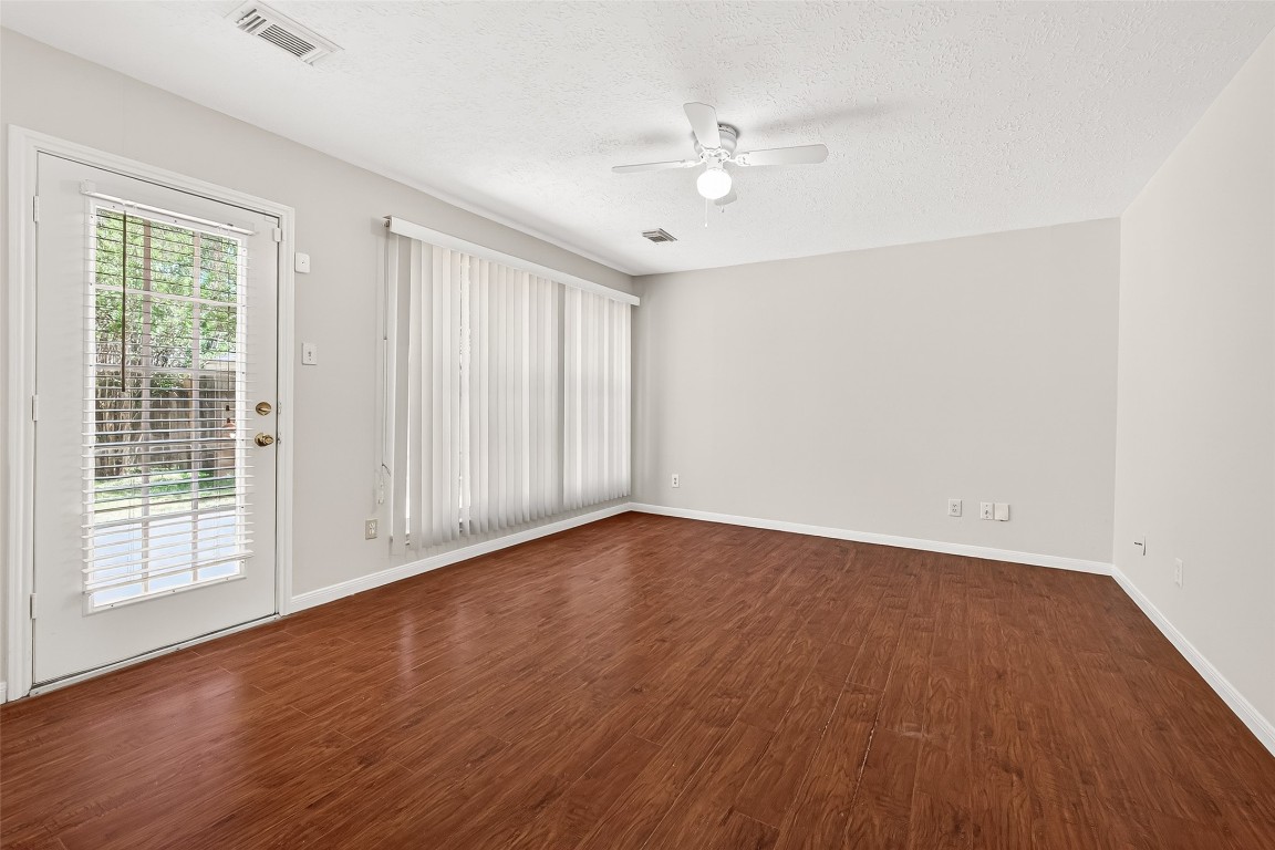3506 Doherty Place Katy, TX 77449 - Photo 22 of 50 a view of an empty room with wooden floor and a window