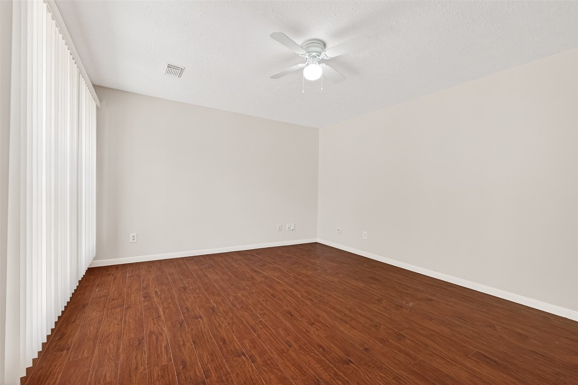 3506 Doherty Place Katy, TX 77449 - Photo 25 of 50 an empty room with wooden floor and fan
