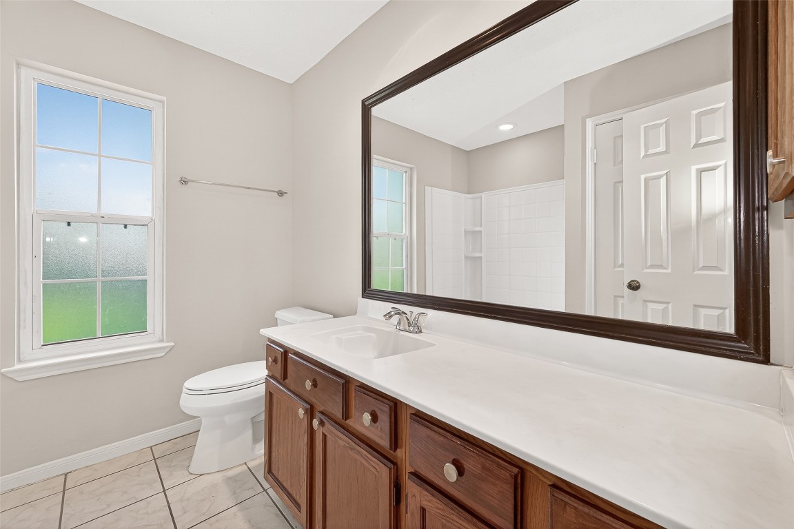 3506 Doherty Place Katy, TX 77449 - Photo 28 of 50 a bathroom with a sink a toilet shower and a mirror