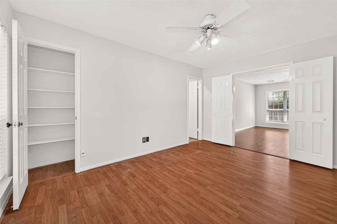 3506 Doherty Place Katy, TX 77449 - Photo 34 of 50 a view of an empty room with a window and wooden floor