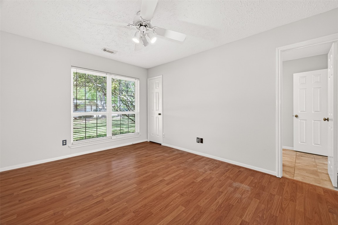 3506 Doherty Place Katy, TX 77449 - Photo 35 of 50 a view of an empty room with wooden floor and a window