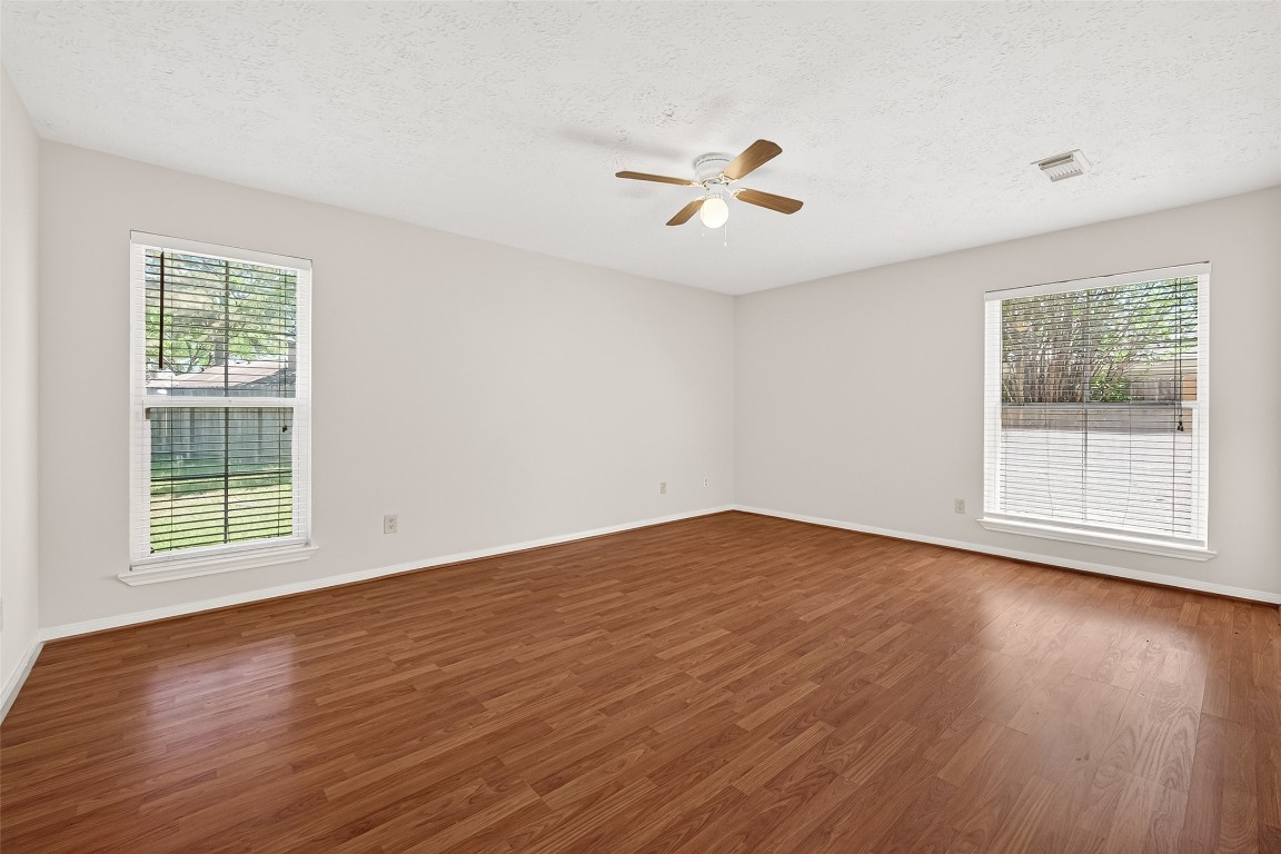 3506 Doherty Place Katy, TX 77449 - Photo 36 of 50 a view of an empty room with wooden floor and a window