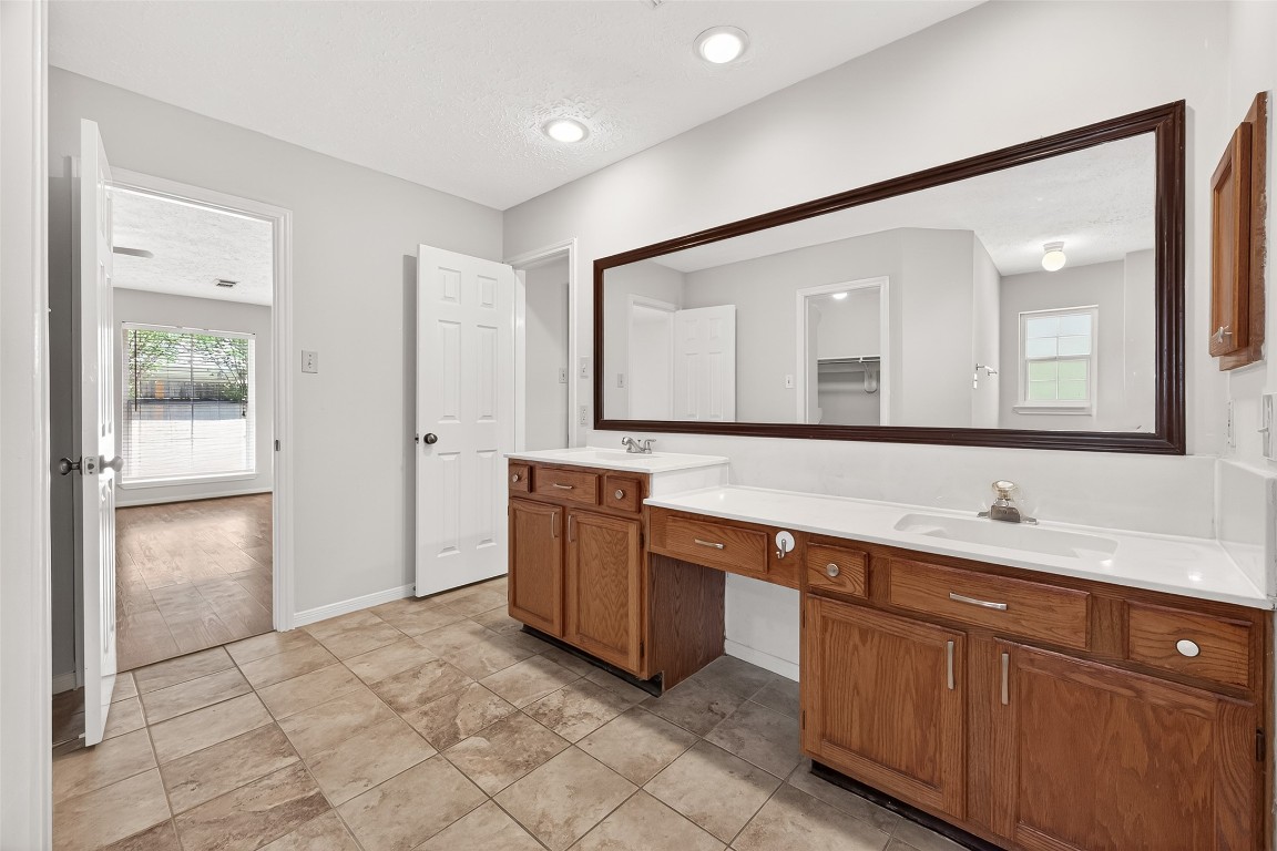 3506 Doherty Place Katy, TX 77449 - Photo 42 of 50 a spacious bathroom with a double vanity sink and a mirror