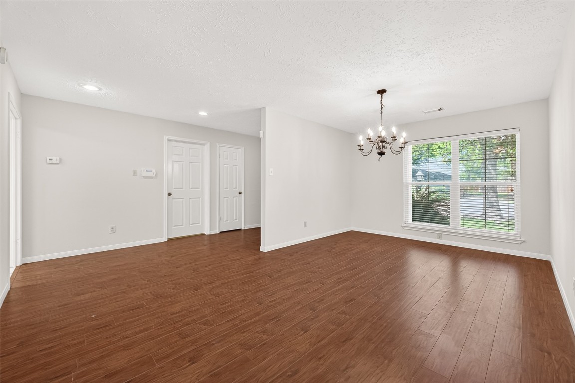 3506 Doherty Place Katy, TX 77449 - Photo 7 of 50 a view of an empty room with wooden floor and a window