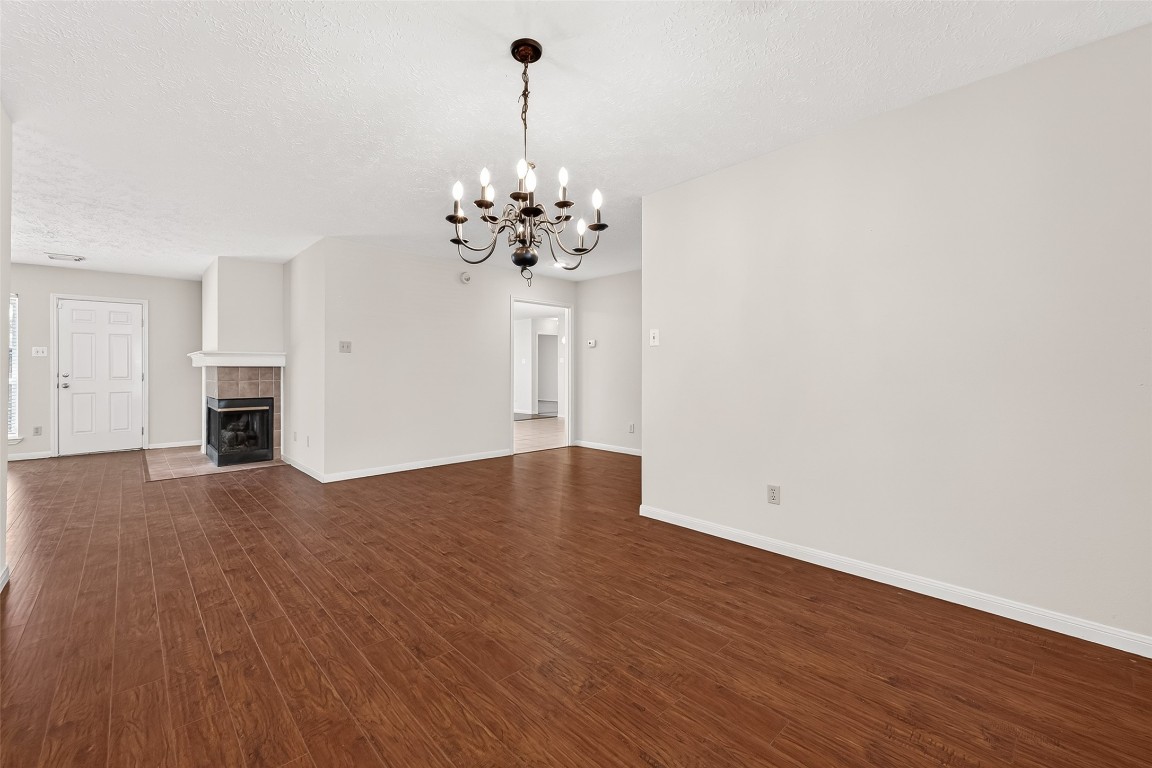 3506 Doherty Place Katy, TX 77449 - Photo 8 of 50 a view of an empty room with wooden floor and a kitchen