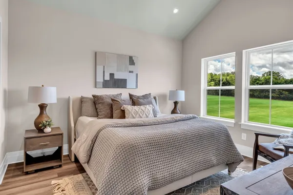 a bedroom with a bed and a window