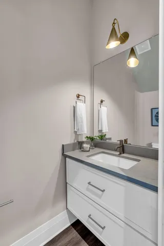 a bathroom with a granite countertop sink and a mirror
