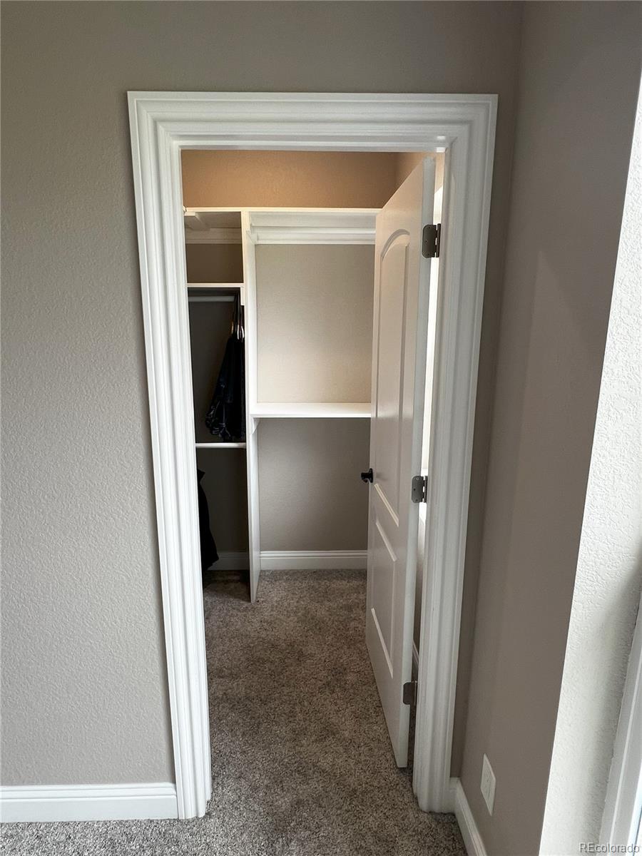 6945 Strasburg Road Strasburg, CO 80136 - Photo 23 of 42 a view of entryway with a hallway