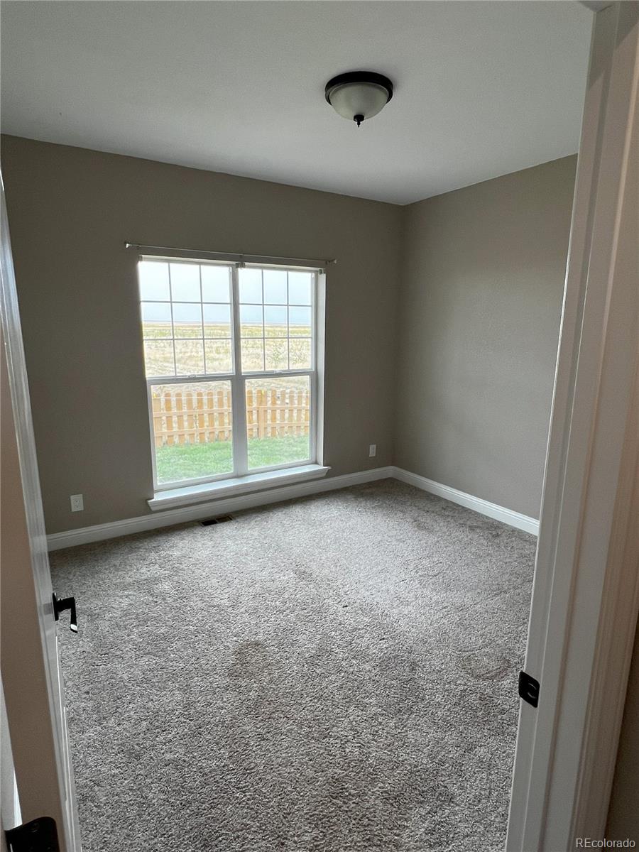 6945 Strasburg Road Strasburg, CO 80136 - Photo 26 of 42 an empty room with a empty space and a window
