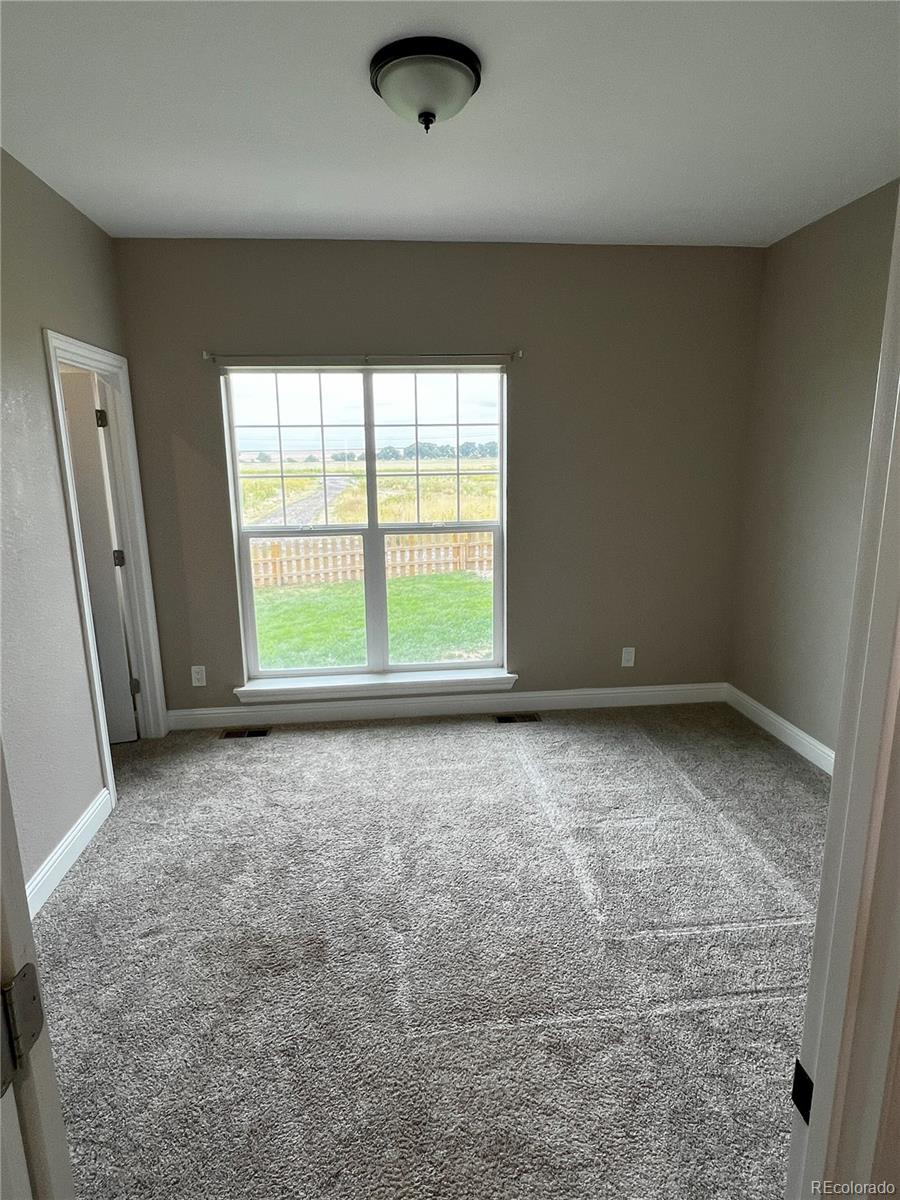 6945 Strasburg Road Strasburg, CO 80136 - Photo 27 of 42 an empty room with a window