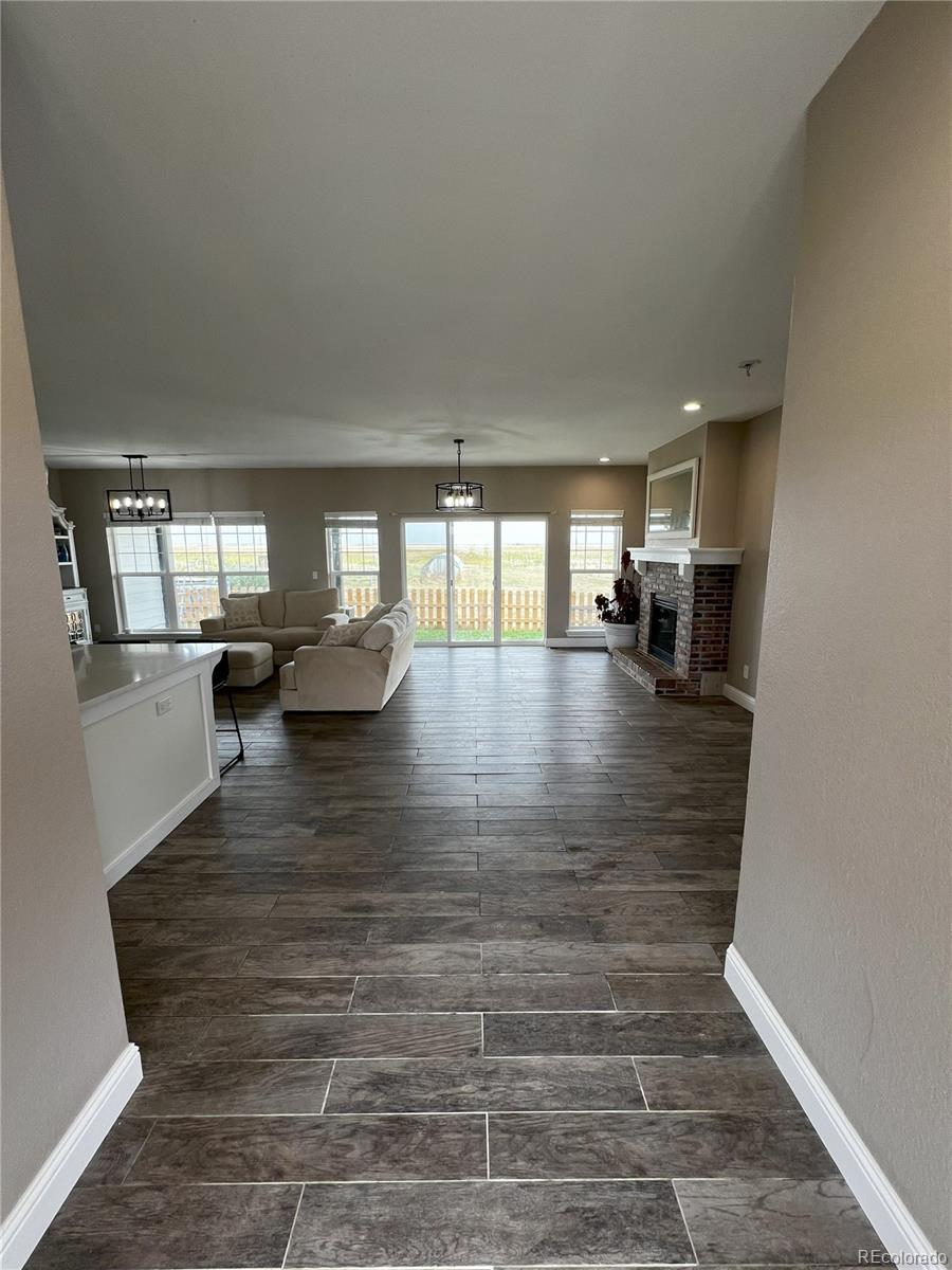 6945 Strasburg Road Strasburg, CO 80136 - Photo 9 of 42 a lobby with furniture and floor to ceiling window