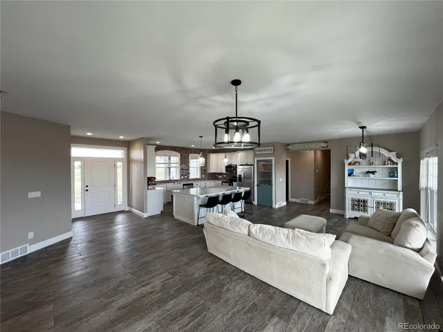 a living room with fireplace furniture and a wooden floor