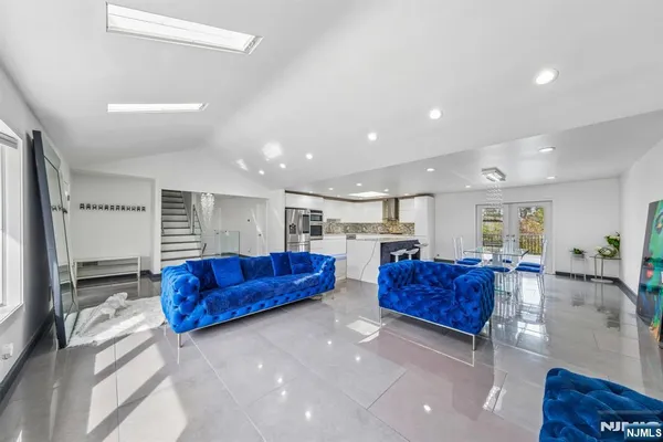 a kitchen with stainless steel appliances kitchen island granite countertop a refrigerator and a stove top oven