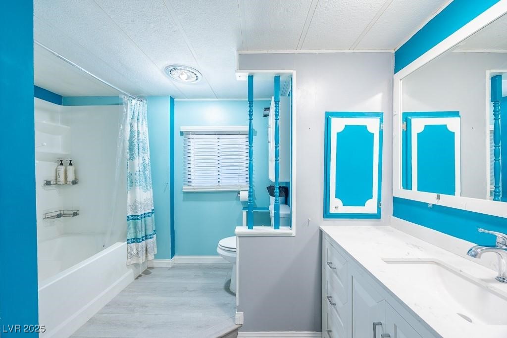 1208 Inca Lane Henderson, NV 89015 - Photo 12 of 21 Bathroom featuring a textured ceiling, vanity, shower / bath combination with curtain, and light wood finished floors