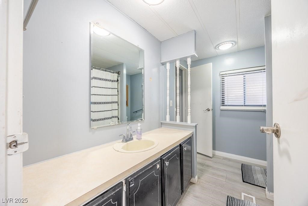 1208 Inca Lane Henderson, NV 89015 - Photo 18 of 21 Bathroom with a shower with curtain, light wood-type flooring, vanity, and beverage cooler