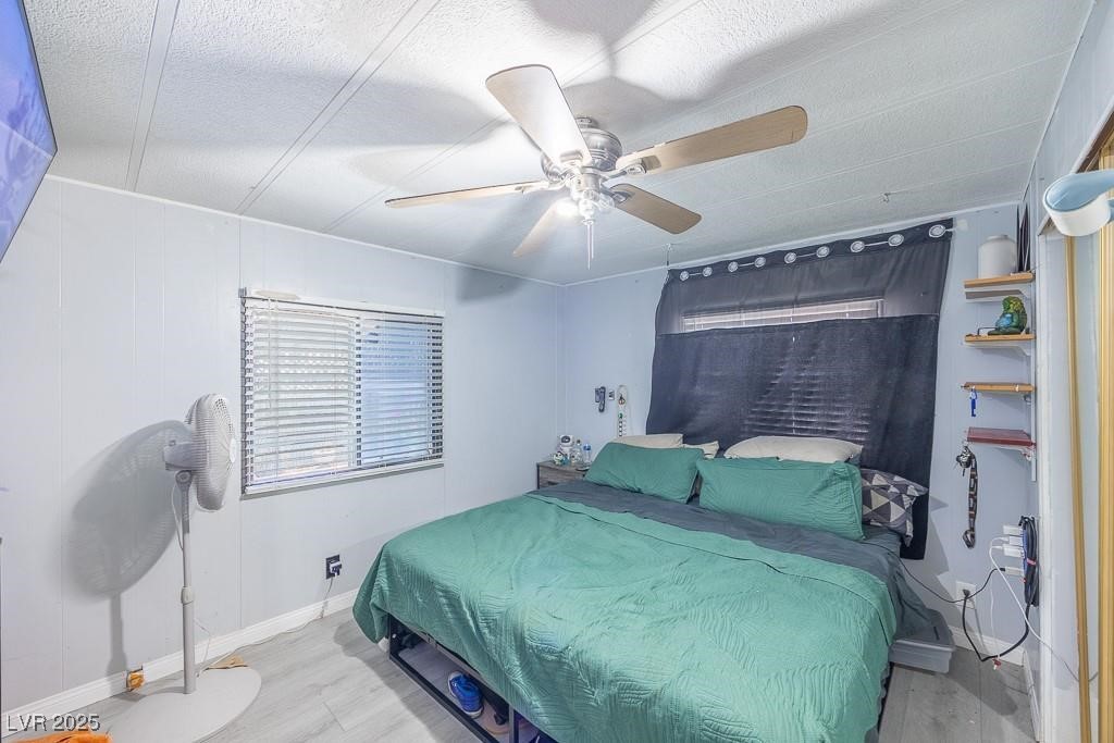 1208 Inca Lane Henderson, NV 89015 - Photo 19 of 21 Bedroom featuring wood finished floors and a ceiling fan