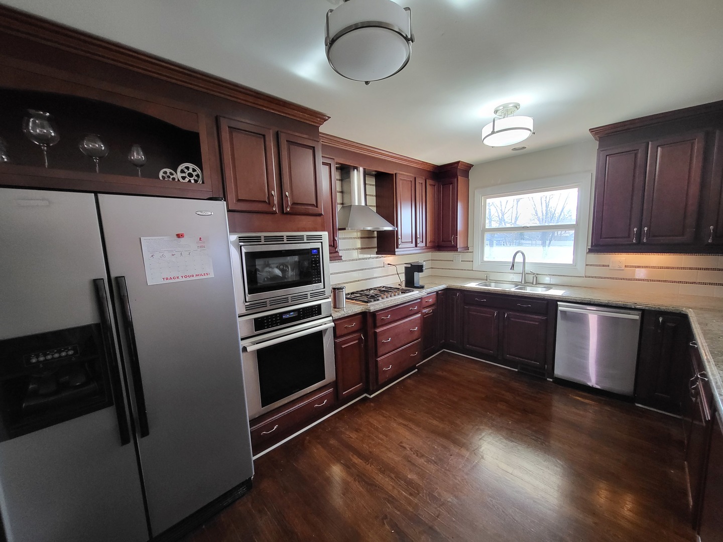 1770 Chippendale Road Hoffman Estates, IL 60169 - Photo 8 of 25 a kitchen with granite countertop stainless steel appliances and wooden cabinets