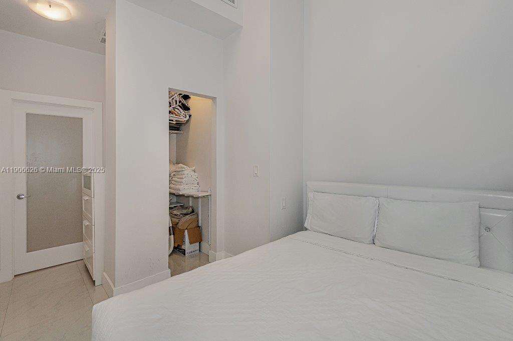 2301 Collins Avenue, Unit 1619 Miami Beach, FL 33139 - Photo 17 of 28 a bedroom with a bed and a window