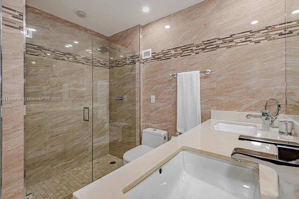 2301 Collins Avenue, Unit 1619 Miami Beach, FL 33139 - Photo 20 of 28 a bathroom with a sink and a shower
