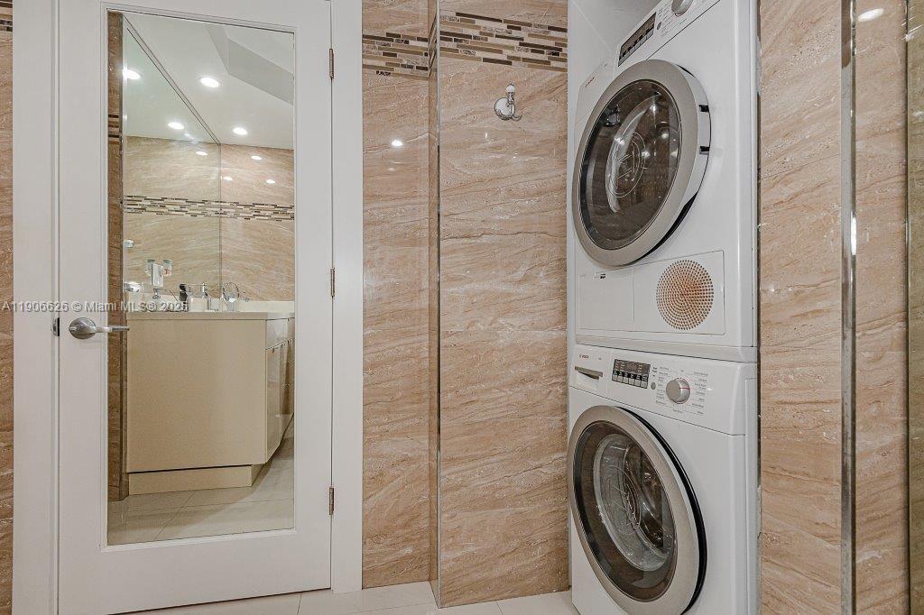 2301 Collins Avenue, Unit 1619 Miami Beach, FL 33139 - Photo 21 of 28 a view of a bathroom with a washer and dryer
