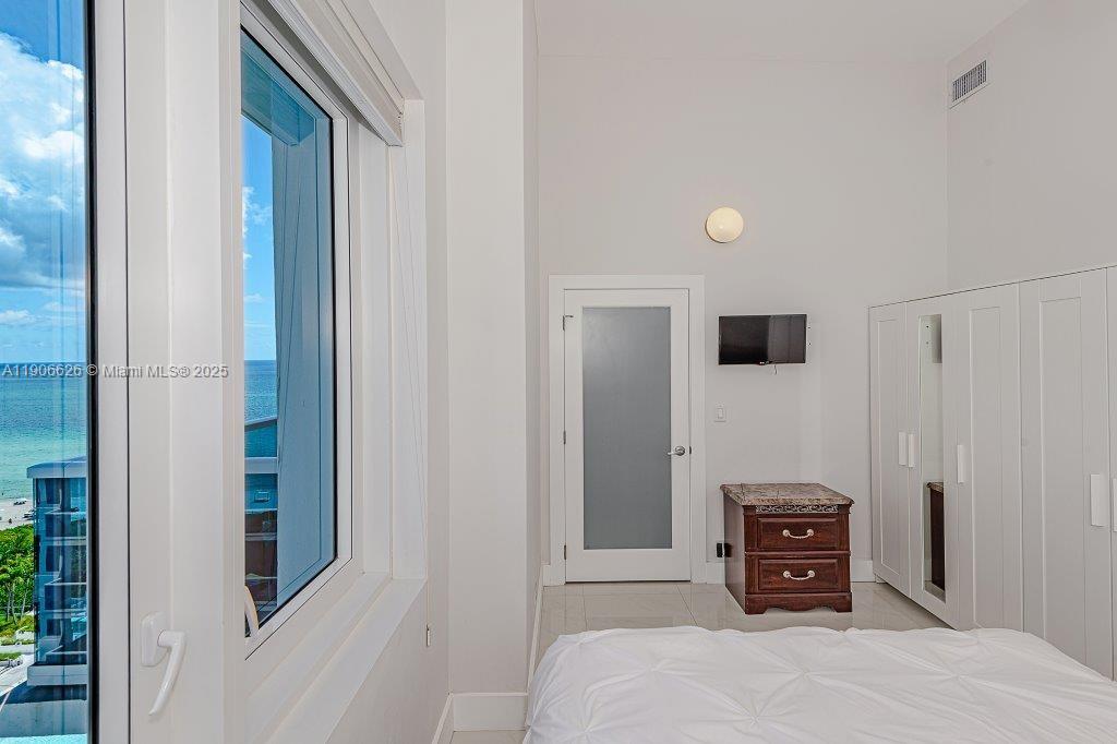 2301 Collins Avenue, Unit 1619 Miami Beach, FL 33139 - Photo 25 of 28 a bedroom with a bed and a tv