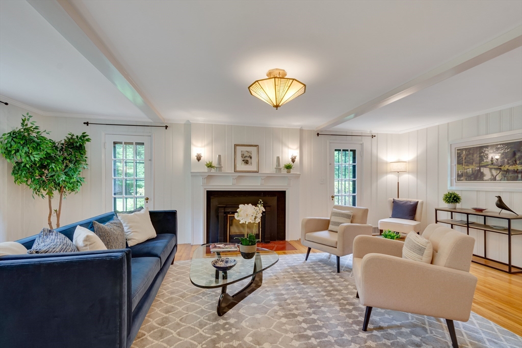 24 Beaver Pond Road Lincoln, MA 01773 - Photo 2 of 35 a living room with furniture a fireplace and a potted plant