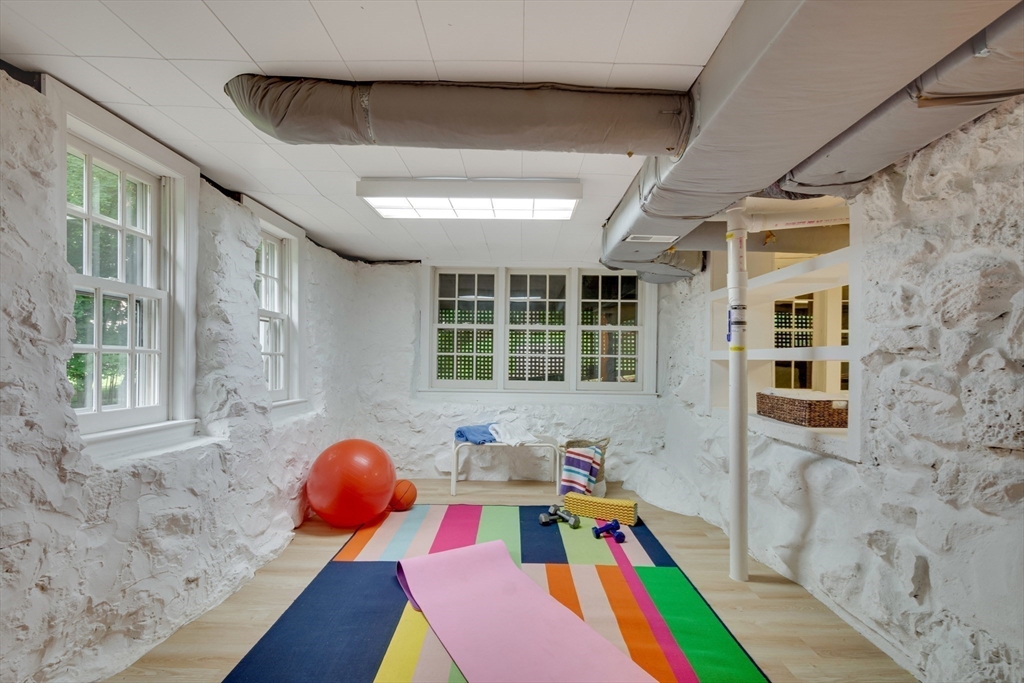 24 Beaver Pond Road Lincoln, MA 01773 - Photo 25 of 35 a bedroom with furniture and a wooden floor