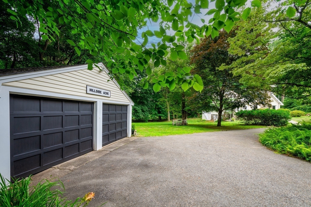 24 Beaver Pond Road Lincoln, MA 01773 - Photo 33 of 35 a view of a house with a yard and garage