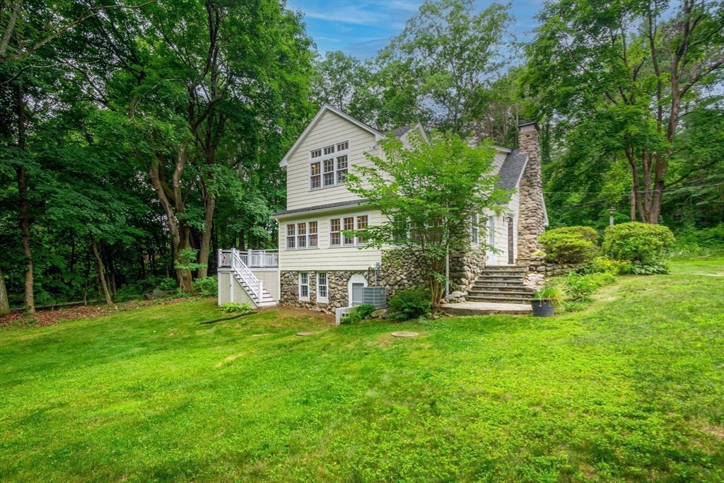 24 Beaver Pond Road Lincoln, MA 01773 - Photo 34 of 35 a front view of a house with garden