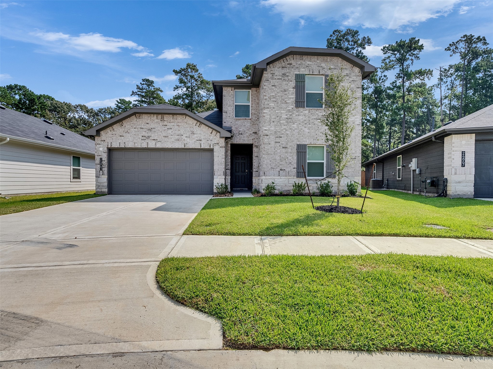 24863 Springbluff Valley Magnolia, TX 77355 - Photo 1 of 25 a front view of a house with a yard and garage