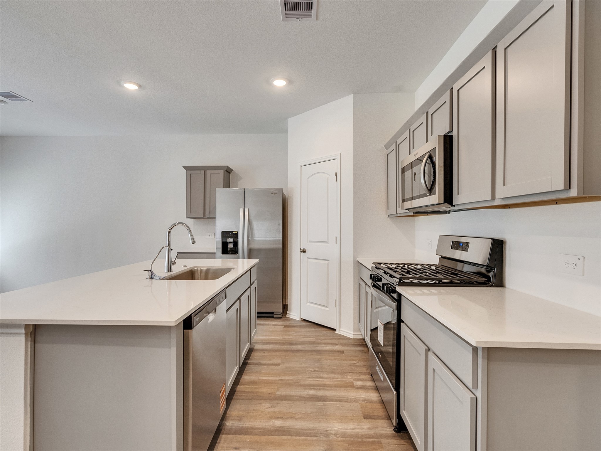 24863 Springbluff Valley Magnolia, TX 77355 - Photo 6 of 25 a kitchen with stainless steel appliances granite countertop a sink stove and refrigerator