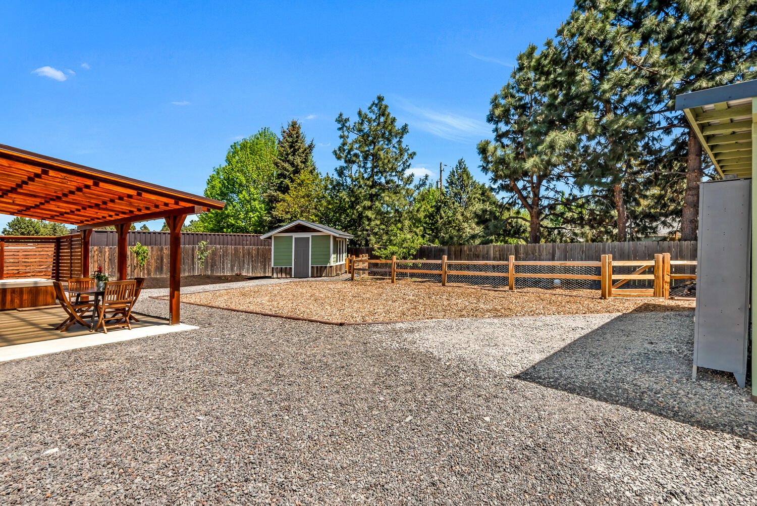 63406 Vogt Road Bend, OR 97701 - Photo 21 of 27 Backyard with sheds and kitchen coop