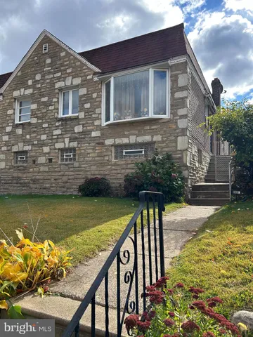 a view of house with swimming pool and a yard