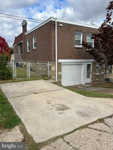 a house that has a tree in front of it
