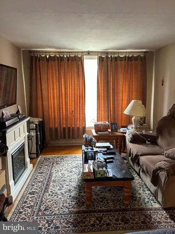 a living room with furniture a window and a rug