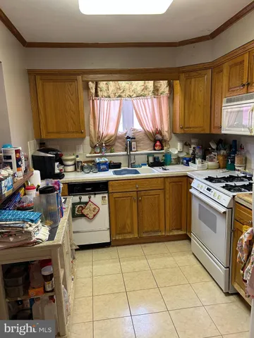 a kitchen with a stove a sink a stove and a refrigerator
