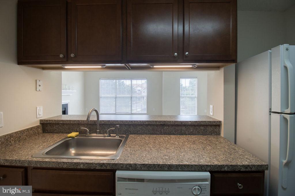 21024 Timber Ridge Terrace, Unit 303 Ashburn, VA 20147 - Photo 13 of 42 View to Living Room From Kitchen Sink