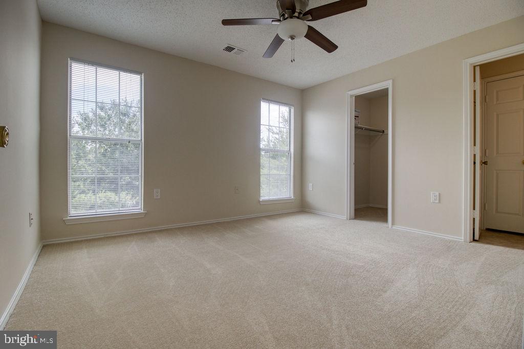 21024 Timber Ridge Terrace, Unit 303 Ashburn, VA 20147 - Photo 27 of 42 Master Bedroom With Walk-In Closet