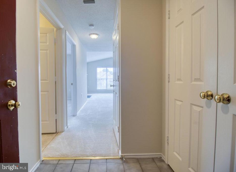 21024 Timber Ridge Terrace, Unit 303 Ashburn, VA 20147 - Photo 5 of 42 Foyer Entry To Condo With Coat Closet