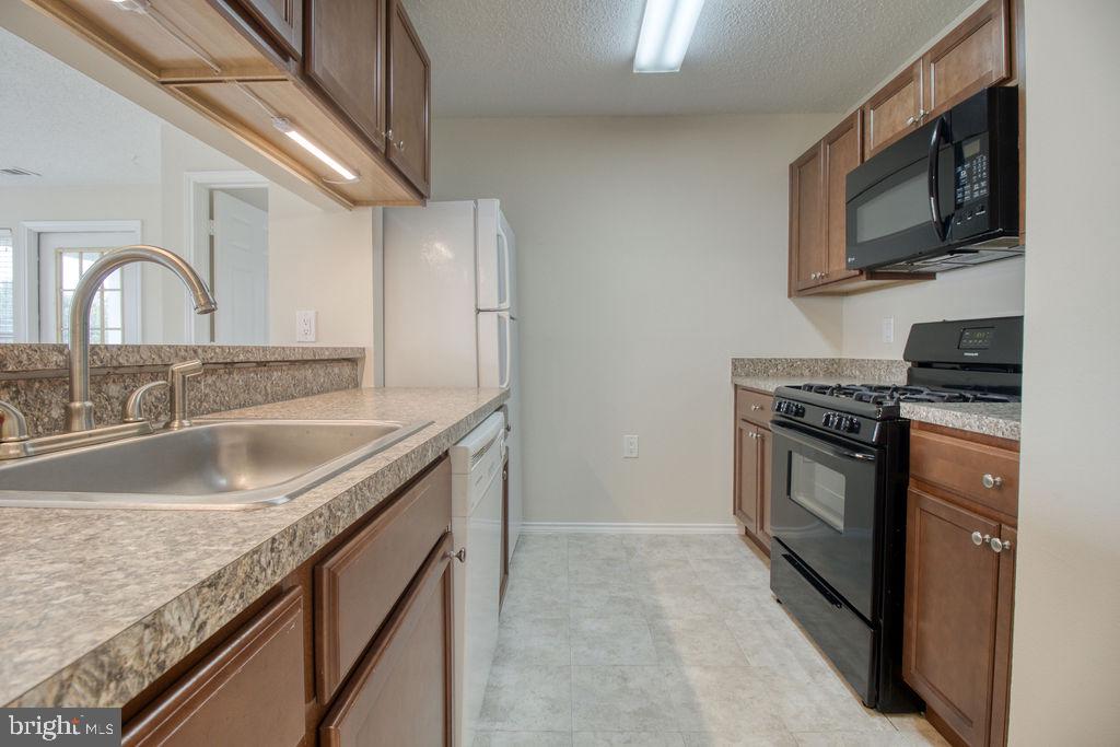 21024 Timber Ridge Terrace, Unit 303 Ashburn, VA 20147 - Photo 10 of 42 Efficient Kitchen Opens To Living Room
